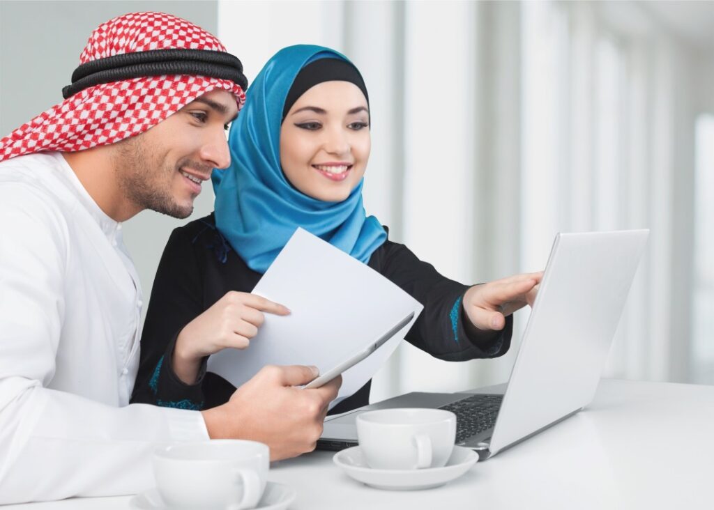 Portrait of arab couple with laptop on background